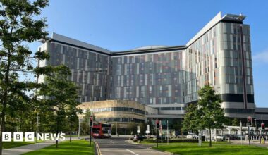 A modern hospital building with multi-coloured panels on its sides