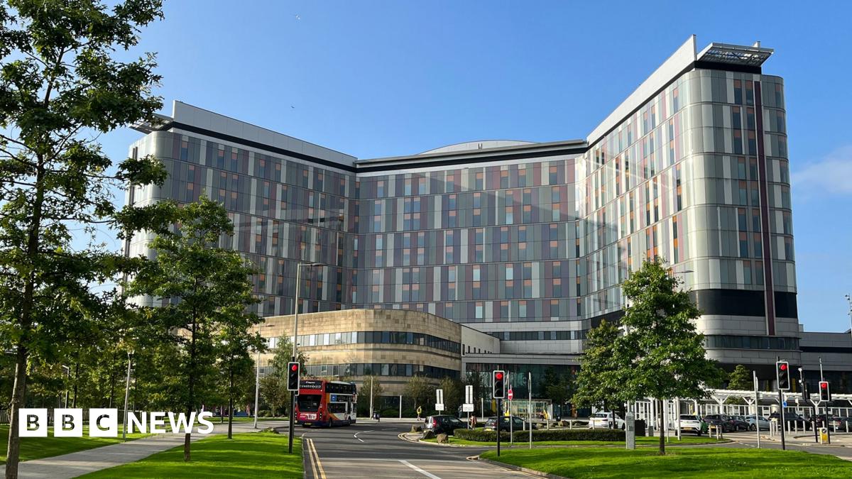 A modern hospital building with multi-coloured panels on its sides