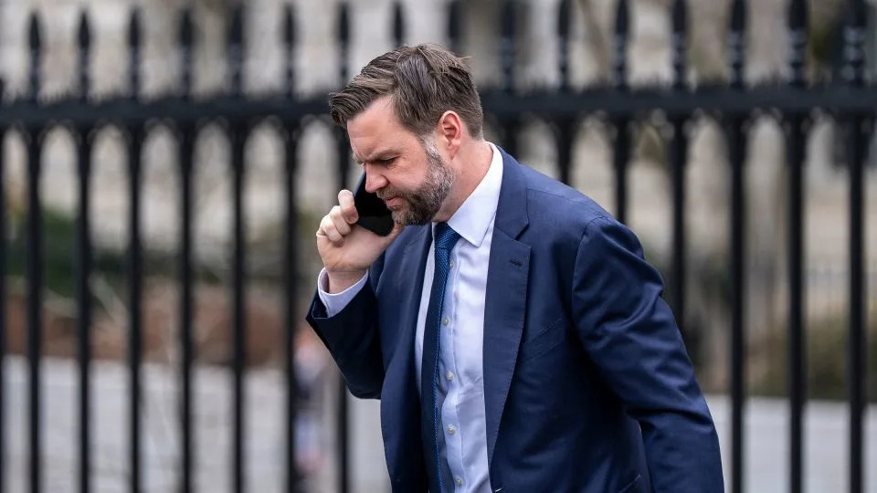 Vice President JD Vance talks on his phone as he walks to the West Wing of the White House on March 6. - Alex Brandon/AP