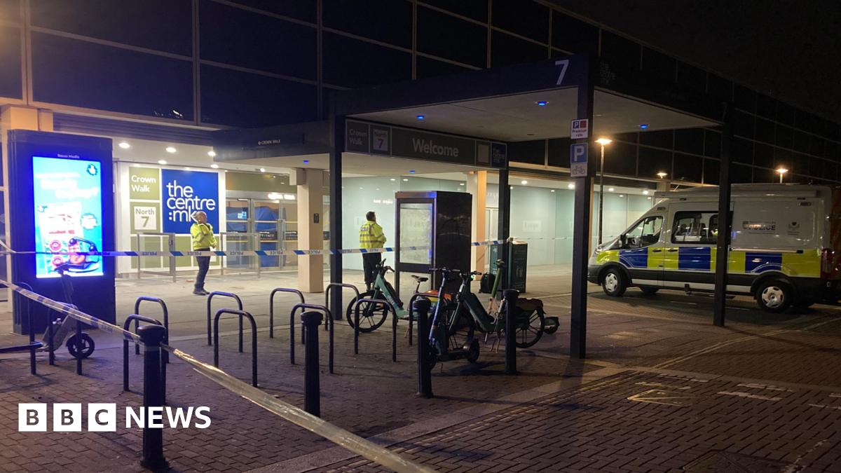A police cordon outside the entrance to the Centre:MK. There are two police officers in yellow high vis jackets and a police van.