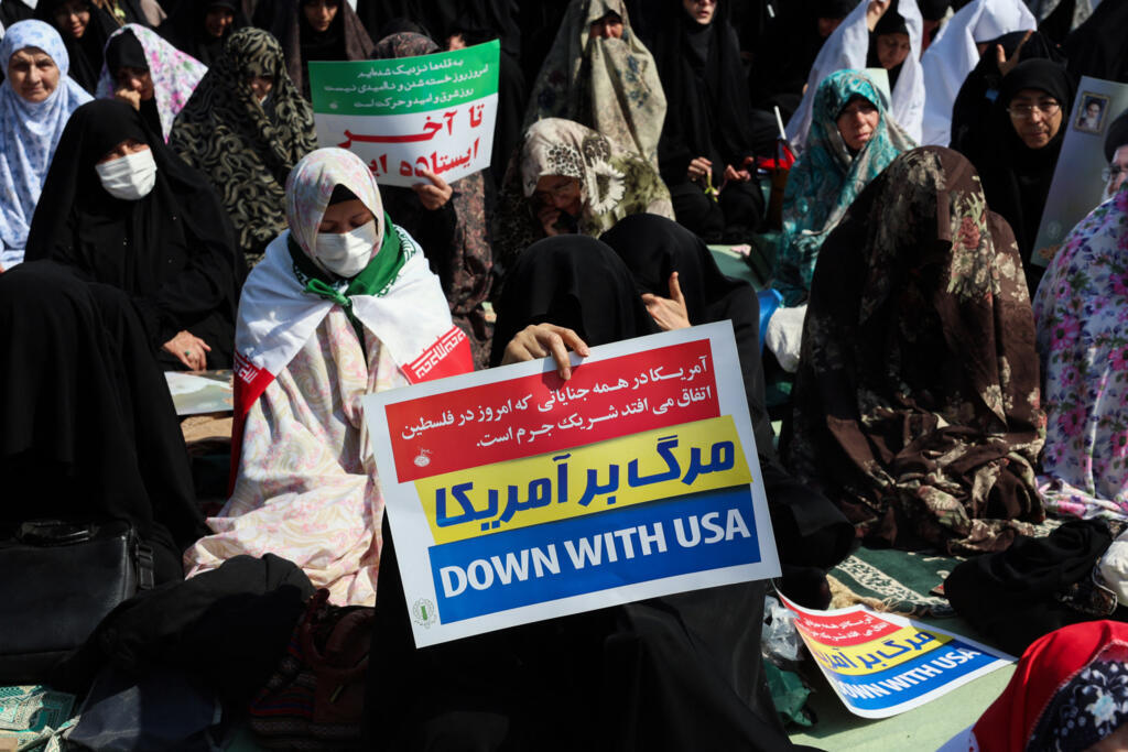 A woman holds an anti-US placard during Friday noon prayers at the compound of the Mosalla mosque in Tehran on 6 March, 2026.
