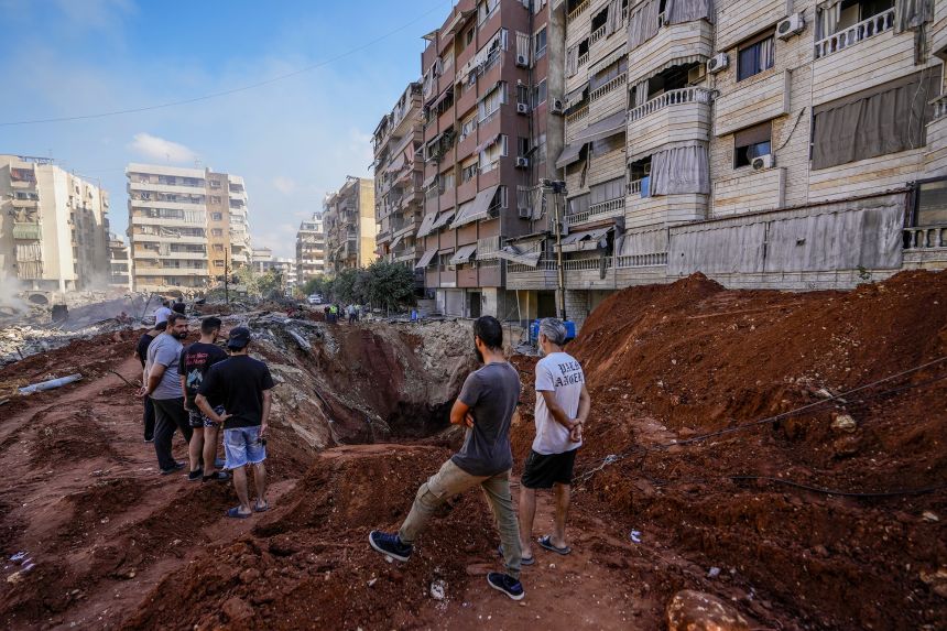 People gather at the site of the assassination of Hezbollah leader Hassan Nasrallah in Beirut's southern suburbs on September 29, 2024.