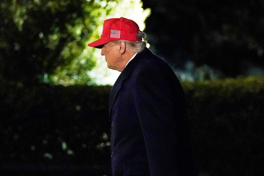 President Donald Trump walks on the South Lawn upon his arrival to the White House on Sunday.