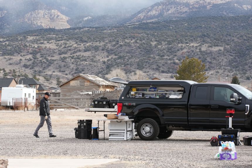 Authorities conduct an investigation at a home where a woman was found dead in Lyman, Utah, on Wednesday.