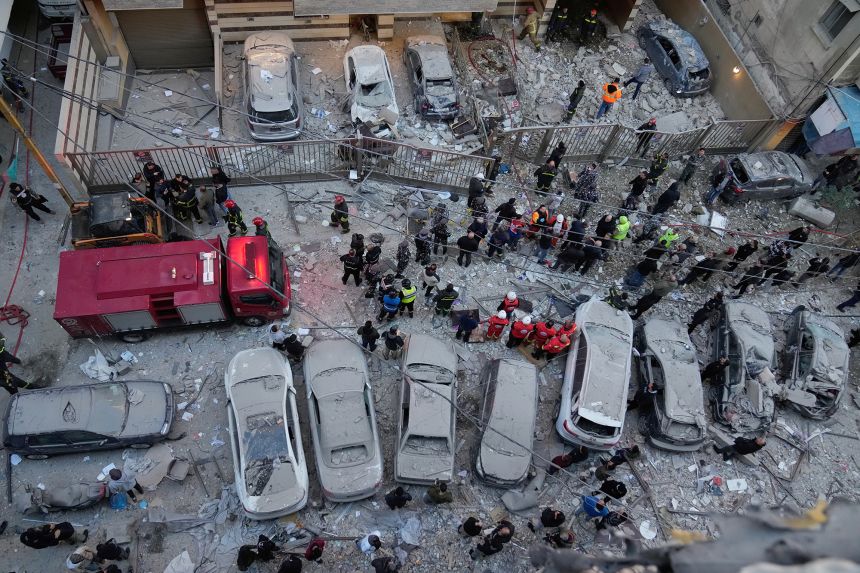 Rescue workers gather at the site where Israeli airstrikes hit apartments in Beirut, Lebanon, on March 11.