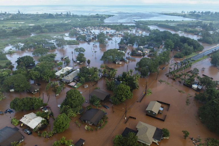 CORRECTS LOCATION TO HALEIWA, NOT WAIALUA - Floodwaters in Haleiwa, Hawaii, on Friday morning, March 20, 2026. (Craig Fujii/Honolulu Civil Beat via AP)