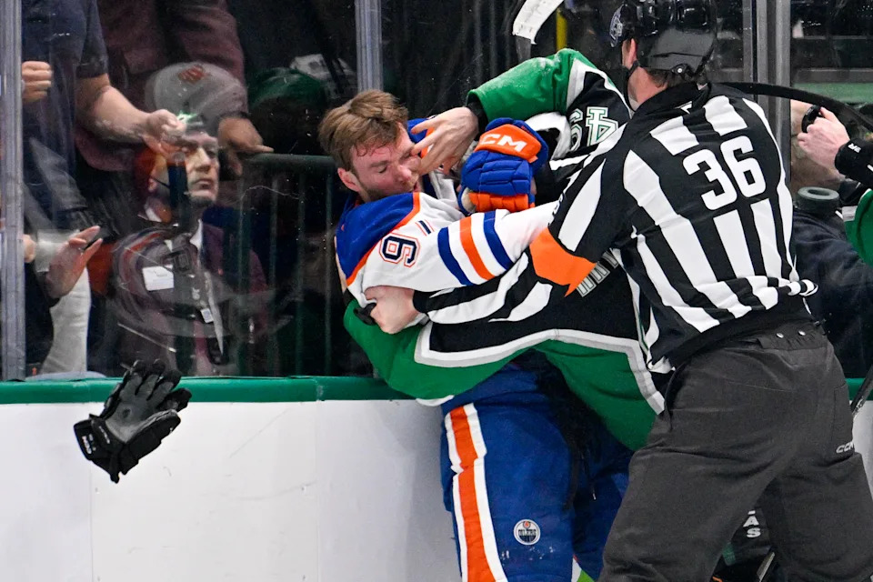 Mar 12, 2026; Dallas, Texas, USA; Dallas Stars center Justin Hryckowian (49) fights Edmonton Oilers center Connor McDavid (97) during the second period at the American Airlines Center. Mandatory Credit: Jerome Miron-Imagn Images