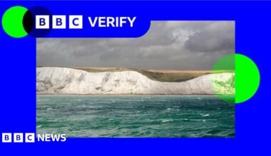 A photo of the white cliffs of Dover against a sky with grey clouds, with BBC Verify branding in bright blue and green around it.