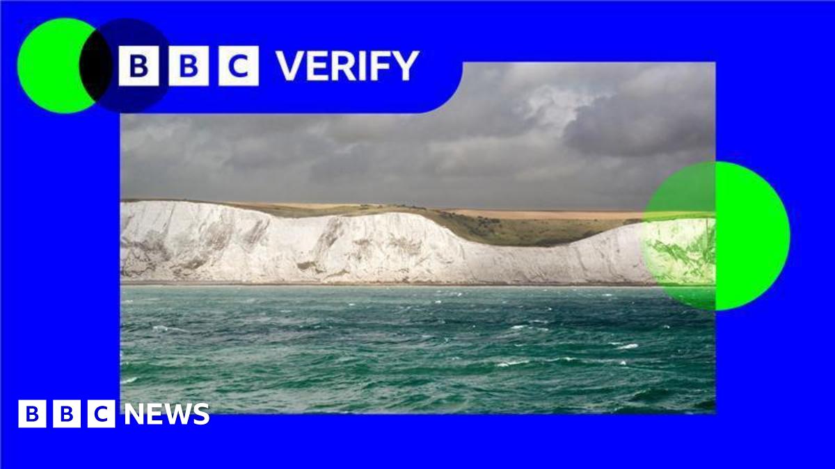A photo of the white cliffs of Dover against a sky with grey clouds, with BBC Verify branding in bright blue and green around it.