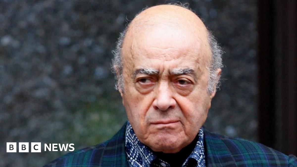 Mohamed al-Fayed wearing tartan blazer and blue and white shirt outside the Harrods department store.