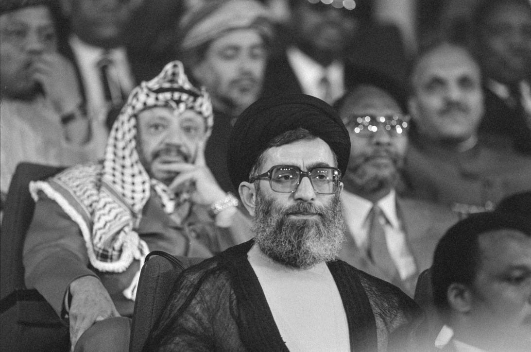 Khamenei listens to a speech during in Harare, Zimbabwe on September 1, 1986.