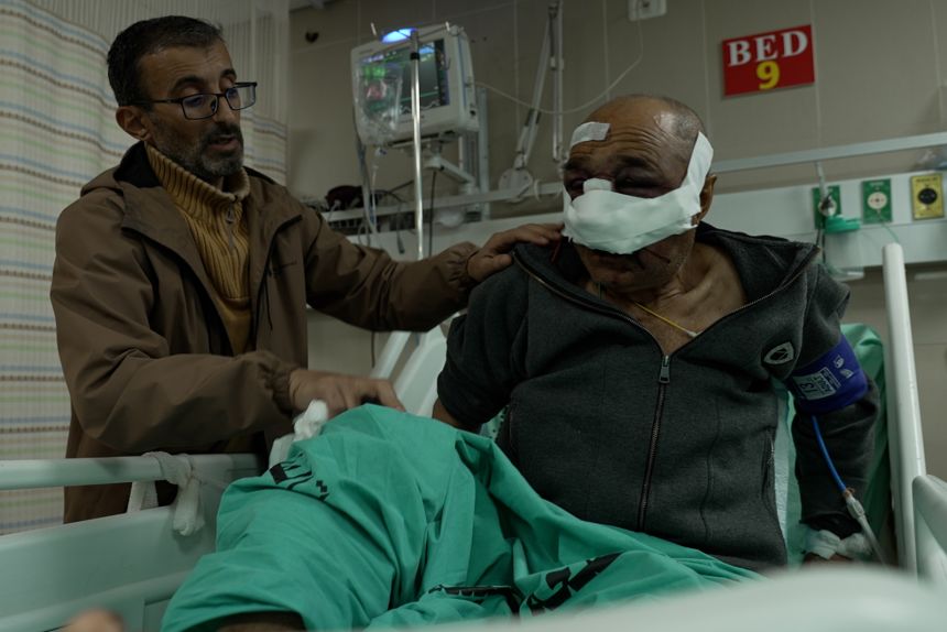 Abdullah Daraghmeh, victim of an Israeli settler attack, with his son.