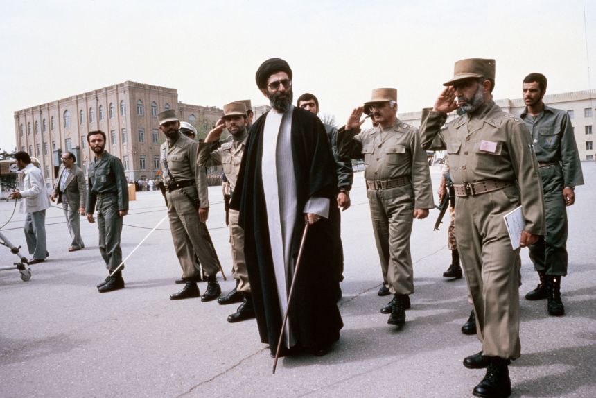 Khamenei (center) flanked by member of the Supreme Defense Council reviews the troops in 1987 in Tehran.