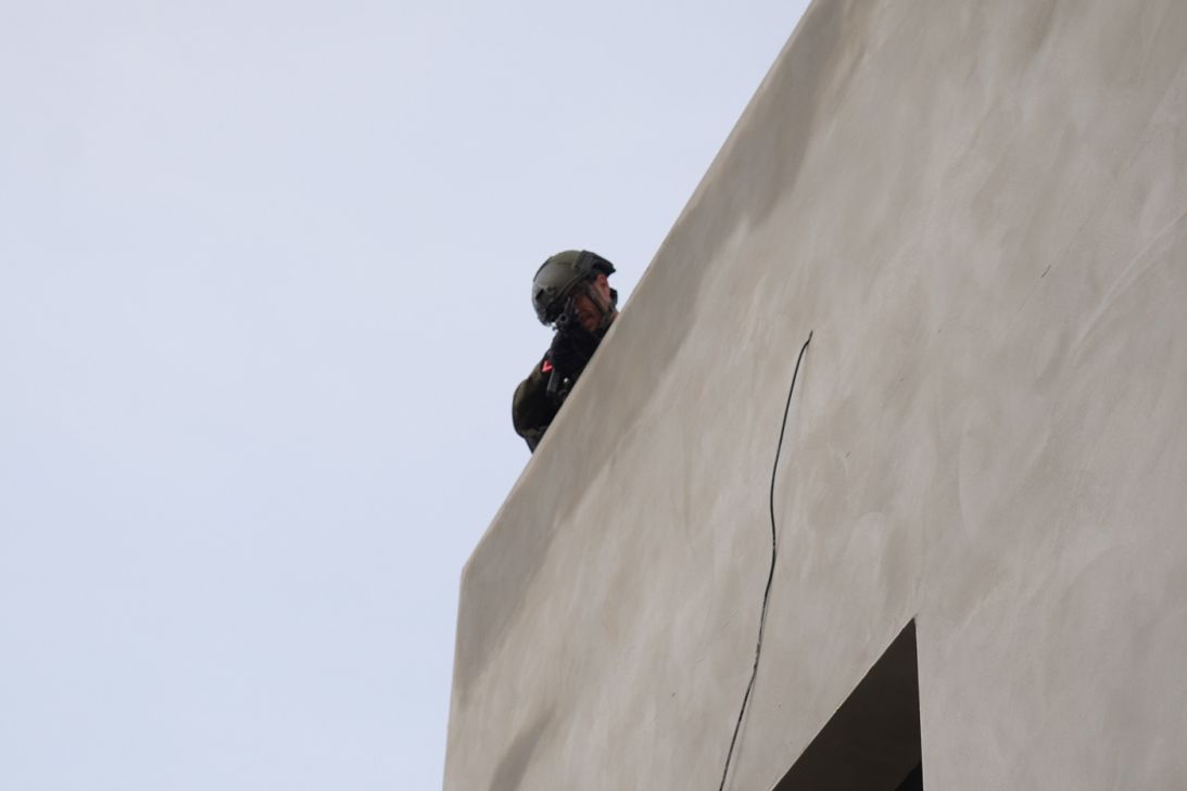 An Israeli soldier points a gun at CNN's Cyril Theophilos.