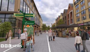 An artist's impression of a modern, pedestrian-only town centre with wide grey pavements and new buildings on both sides. People walk, shop and browse small market stalls under umbrellas.