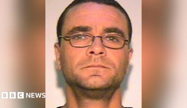 Andrew Malkinson with short brown hair, glasses and light stubble. The image was issued by police.