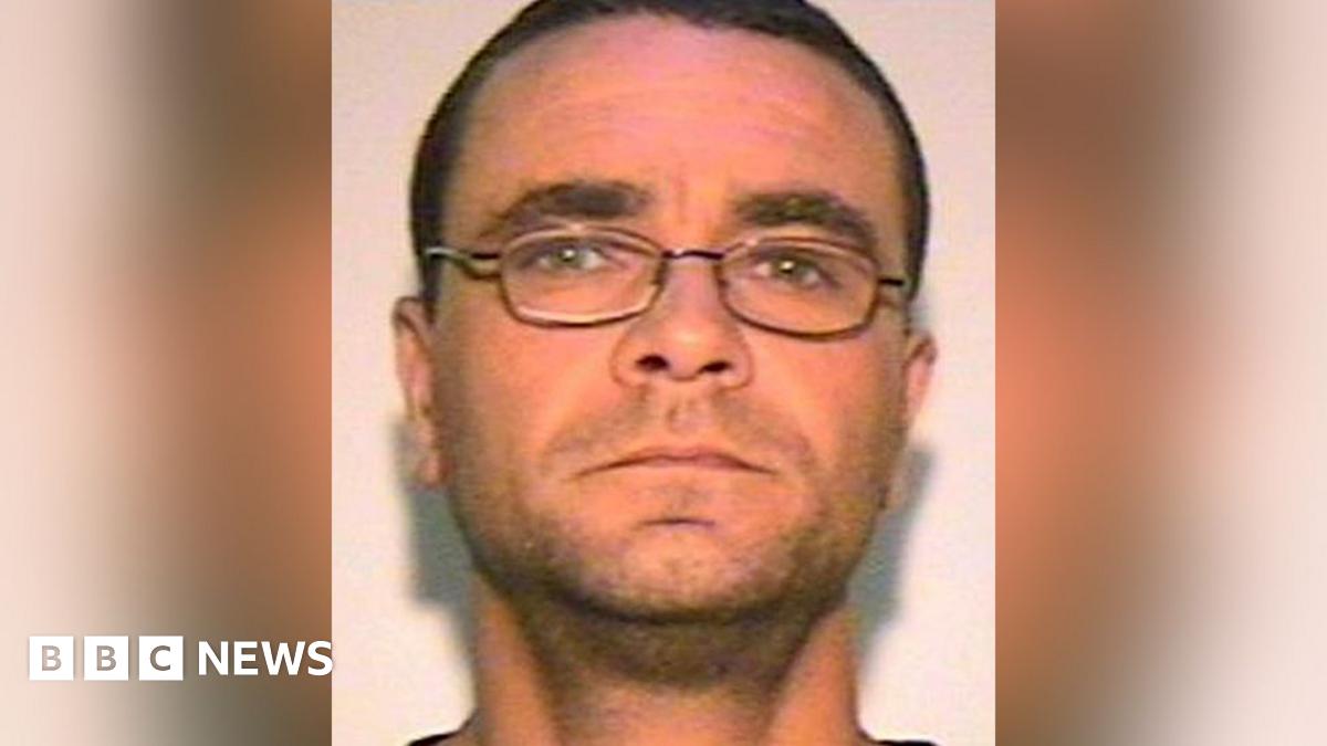 Andrew Malkinson with short brown hair, glasses and light stubble. The image was issued by police.