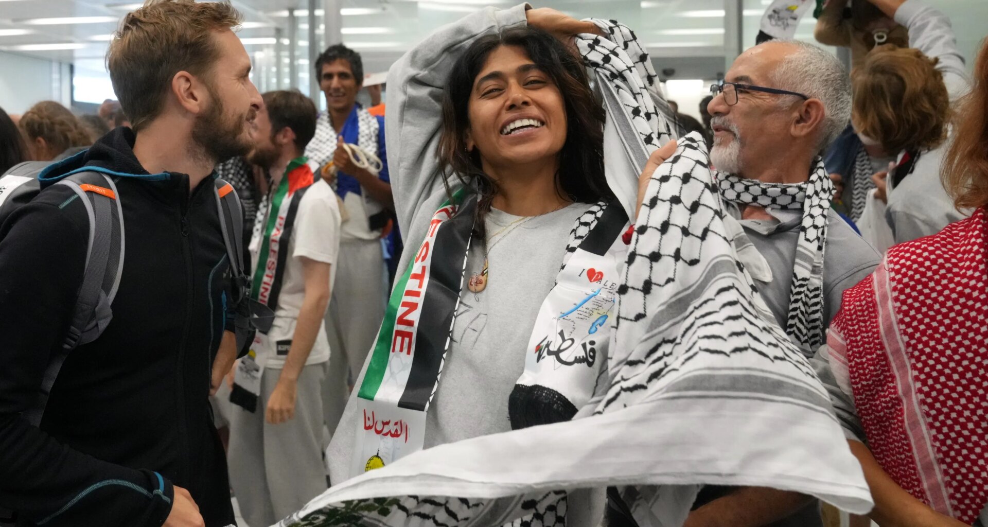 Woman smiles after arriving at an airport.