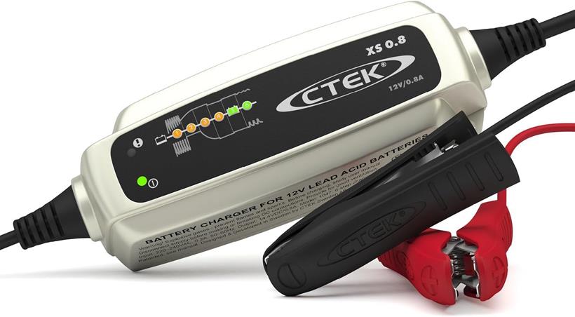 CTEK trickle charger and its red and black crocodile clips on a white background