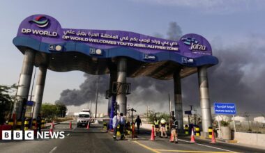 Smoke billows from behind the signage of the Jebel Ali port