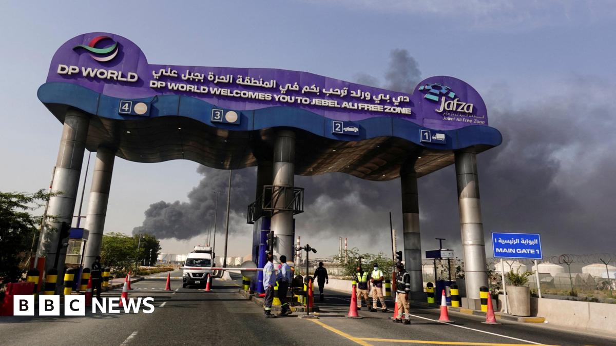 Smoke billows from behind the signage of the Jebel Ali port