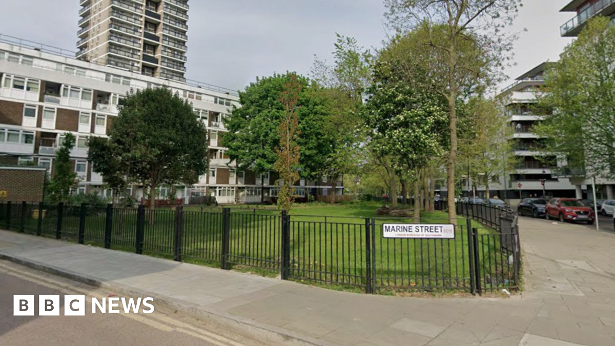 A general view of  a street in Bermondsey. A road name sign is attached to a metal fence, which reads: Marine Street.