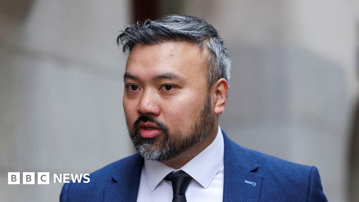 Defendant Chi Leung Wai, also known as Peter Wai, arrives at the Old Bailey, wearing a white shirt, dark tie and blue suit. He has a short salt-and-pepper beard and hair.