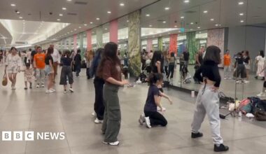 Young Singaporeans practising dance routines in front of the mirrors at Bayfront MRT station