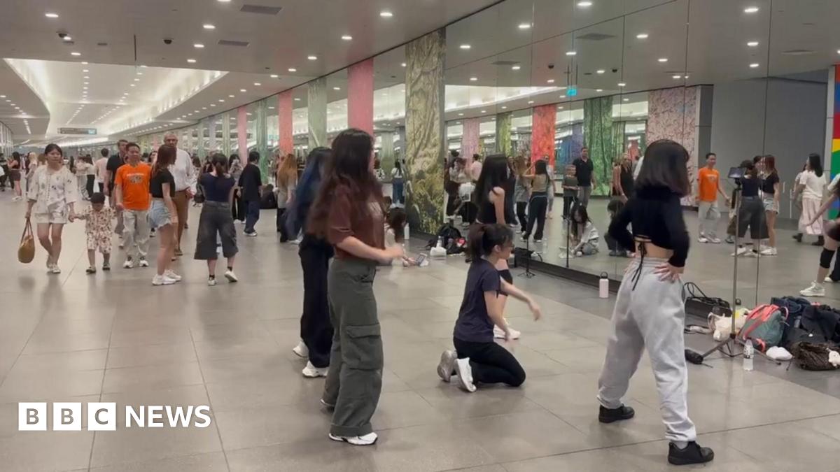 Young Singaporeans practising dance routines in front of the mirrors at Bayfront MRT station