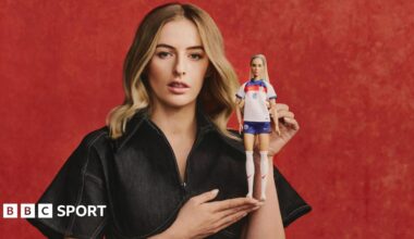 Chloe Kelly poses with the Barbie doll of her likeness