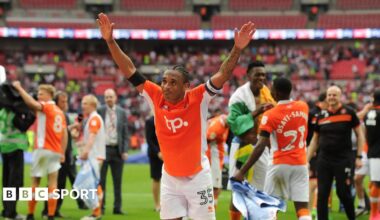 Neil Danns, while playing for Blackpool, celebrates to the fans with his arms out wide after his side's victory against Exeter City in the League Two play-off final at Wembley back in 2017.