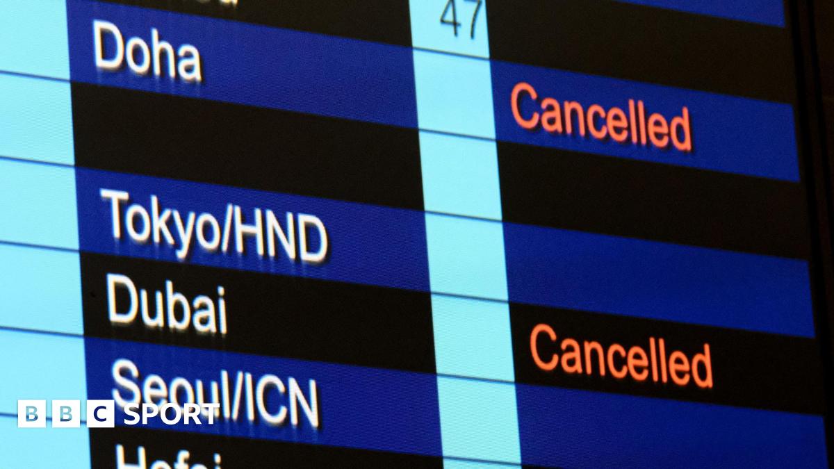 Cancelled flights to Dubai and Doha shown on flight information display at Hong Kong International Airport