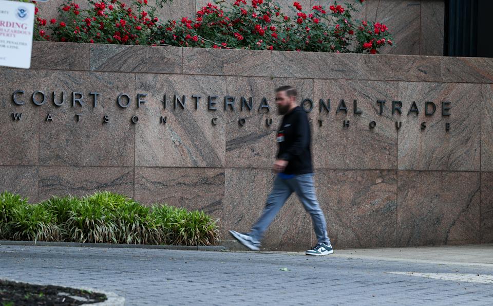 NEW YORK, NEW YORK - MAY 29:  People walk past the United States Court of International Trade, Watson Courthouse in lower Manhattan on May 29, 2025 in New York City. In a ruling that surprised many, the Manhattan-based trade court ruled in an opinion by a three-judge panel that a 1977 law called the International Emergency Economic Powers Act (IEEPA) does not grant Trump 