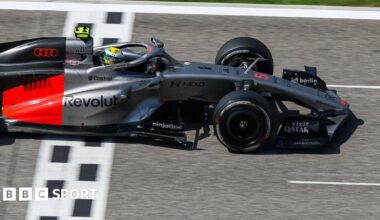 Lewis Hamilton drives the new Ferrari on track in Bahrain, with a McLaren in the background