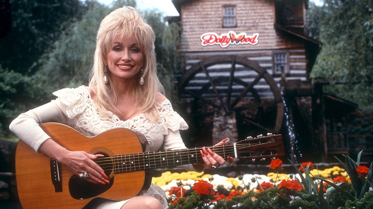 Dolly Parton plays guitar at Dollywood
