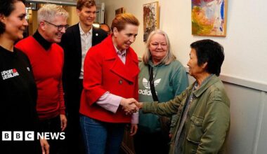 Denmark's Prime Minister and Social Democrats' leader Mette Frederiksen (C) meets Greenlandic voters on election day, in Aalborg, on March 24, 2026