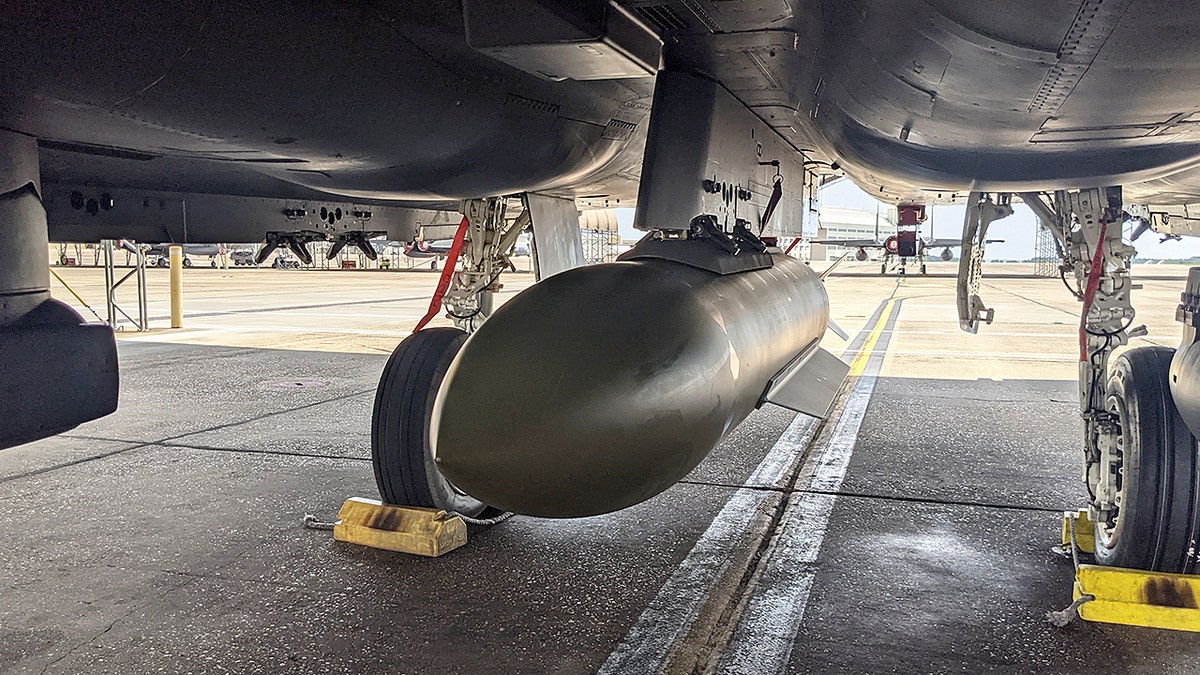 A bomb underneath a fighter plane