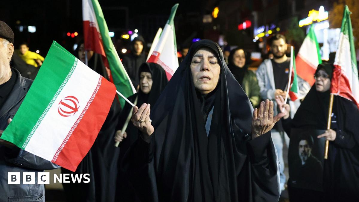 People wave national flags and hold portraits of Iran's supreme leader Mojtaba Khamenei as they march in support of the Iranian armed forces in central Tehran on March 25, 2026.