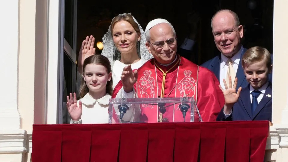 (From left) Crown Princess Gabriella, Princess Charlene of Monaco, Pope Leo XIV, Prince Albert II of Monaco, and Crown Prince Jacques wave from the Gallery of Hercules balcony at the Prince's Palace in Monaco on Sunday. - Gregorio Borgia/AP