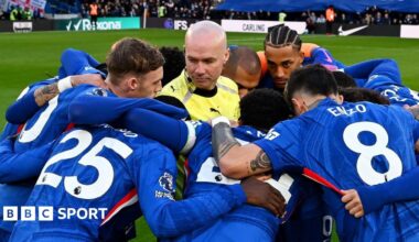 Paul Tierney in the middle of Chelsea's huddle