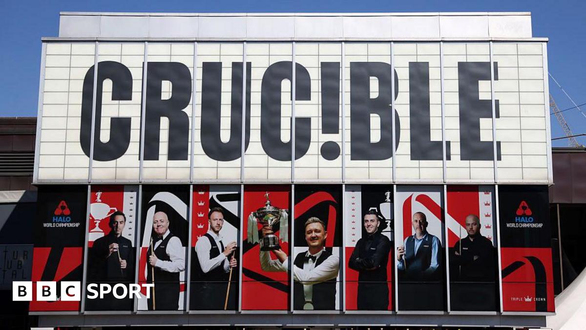 Sheffield's Crucible Theatre during the World Snooker Championship, featuring large pictures of players covering large windows on the building