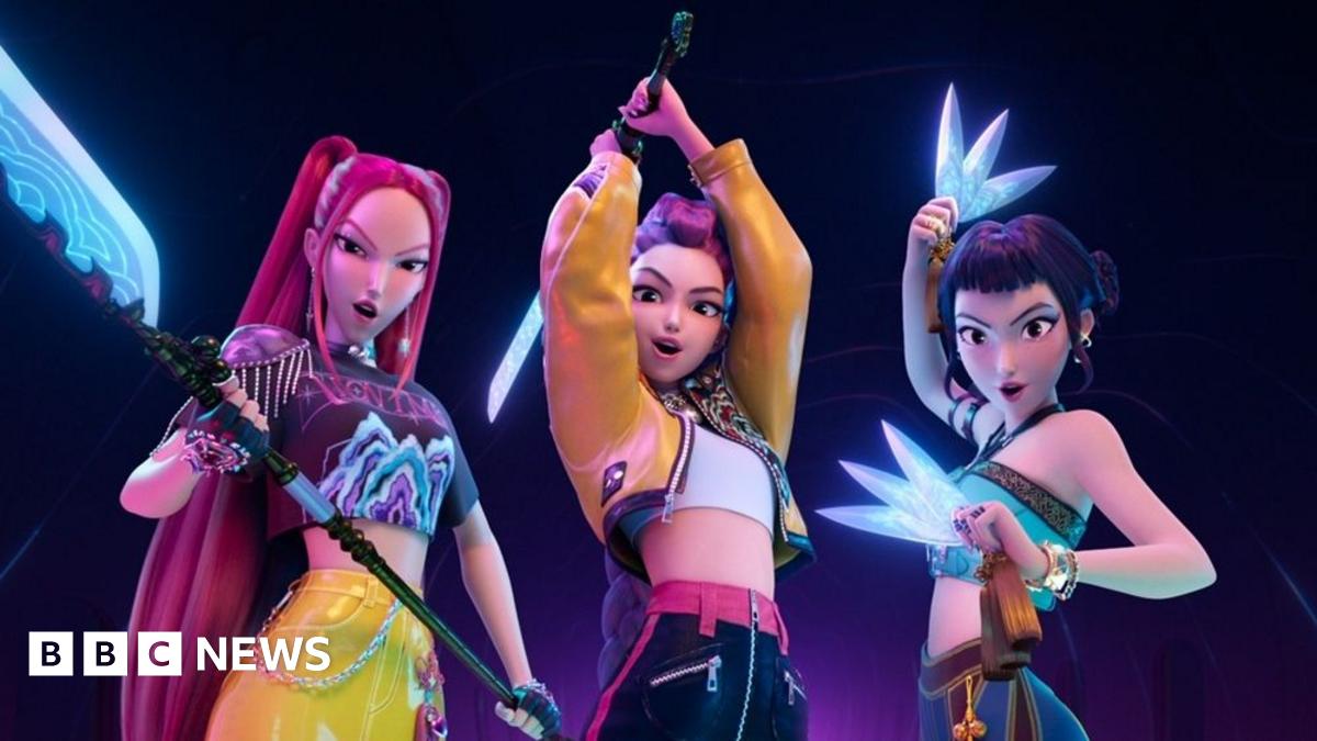 Children posing around large cut-outs of characters from K-pop Demon Hunters