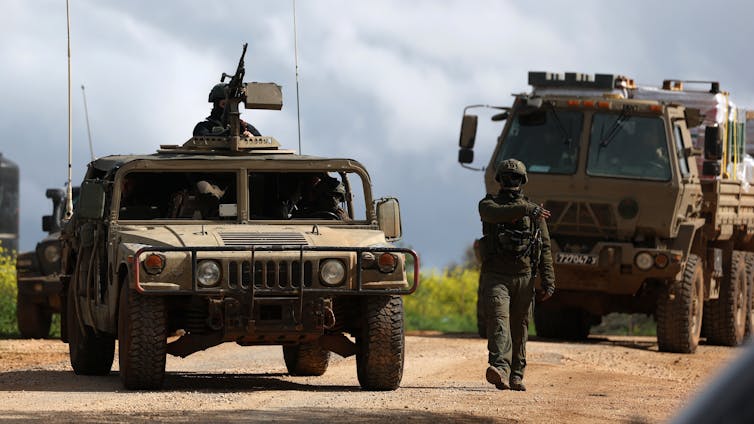 Israeli soldiers and military vehicles at an undisclosed position near the Israel-Lebanon border.
