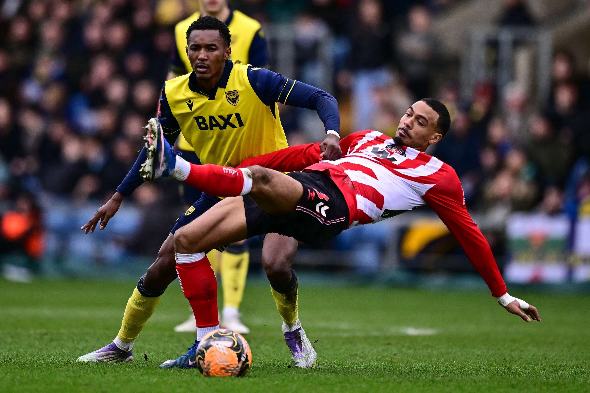 Oxford United’s Congolese defender #37 Christ Makosso (L) clashes with Sunderland’s French striker #18 Wilson Isidor (R) during the English FA Cup fourth round football match between Oxford United and Sunderland at the Kassam Stadium in Oxford, west of London, on February 15, 2026. (Photo by Ben STANSALL / AFP via Getty Images) / RESTRICTED TO EDITORIAL USE. No use with unauthorized audio, video, data, fixture lists, club/league logos or ‘live’ services. Online in-match use limited to 120 images. An additional 40 images may be used in extra time. No video emulation. Social media in-match use limited to 120 images. An additional 40 images may be used in extra time. No use in betting publications, games or single club/league/player publications. /