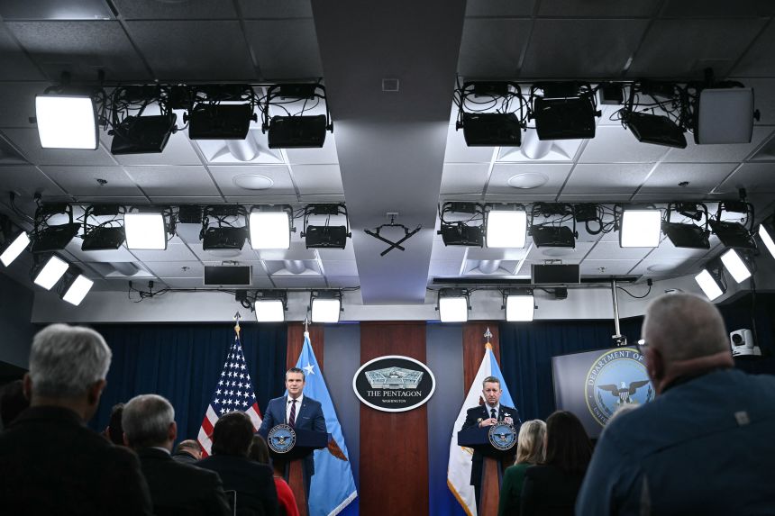 Defense Secretary Pete Hegseth and the Chairman of the Joint Chiefs of Staff Gen. Dan Caine speak during a press conference at the Pentagon on Monday.