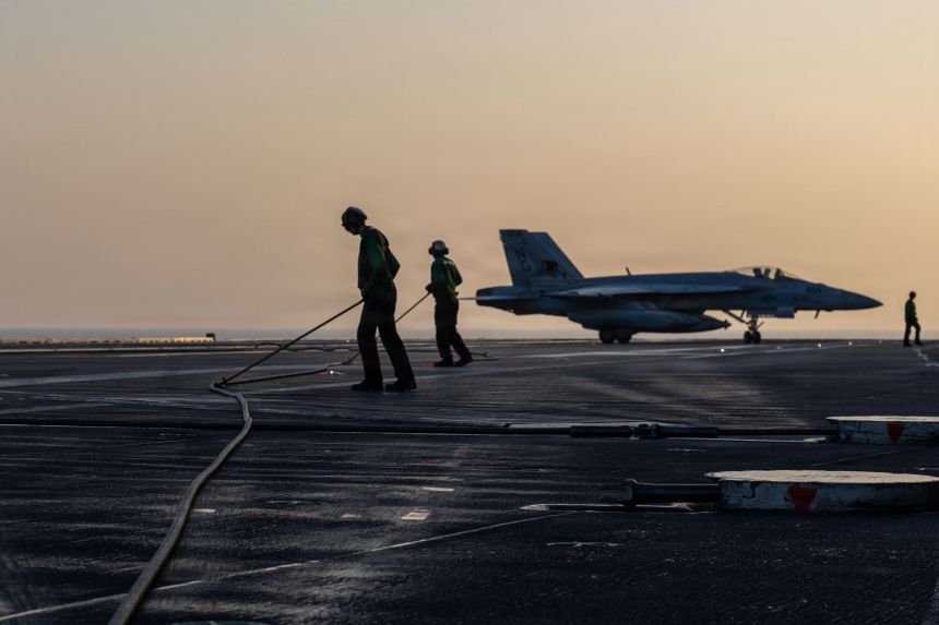 In this US Navy handout image, an F/A-18E Super Hornet, attached to Strike Fighter Squadron 14, taxis the flight deck after an arrested landing on Nimitz-class aircraft carrier USS Abraham Lincoln in support of Operation Epic Fury on March 1, 2026.