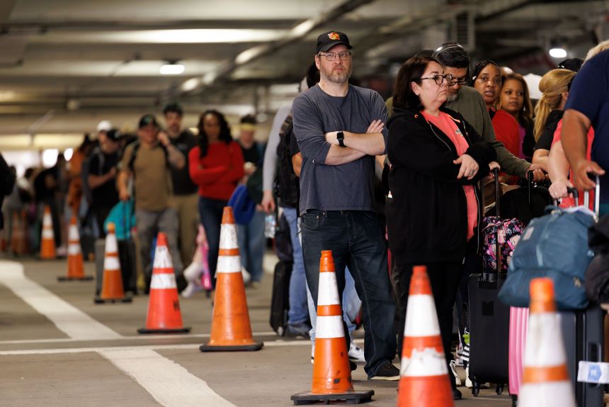 Travelers wait in line to get into a Transportation Security Administration checkpoint at William P. Hobby Airport in Houston, Texas, US, on Monday, March 9.