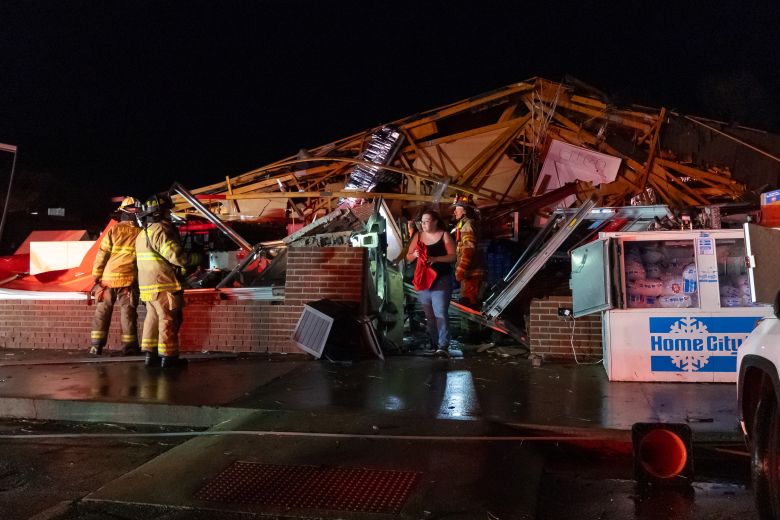 An employee emerges from the rubble of a Family Dollar destroyed by a tornado in Lake Village, Indiana, on March 10.