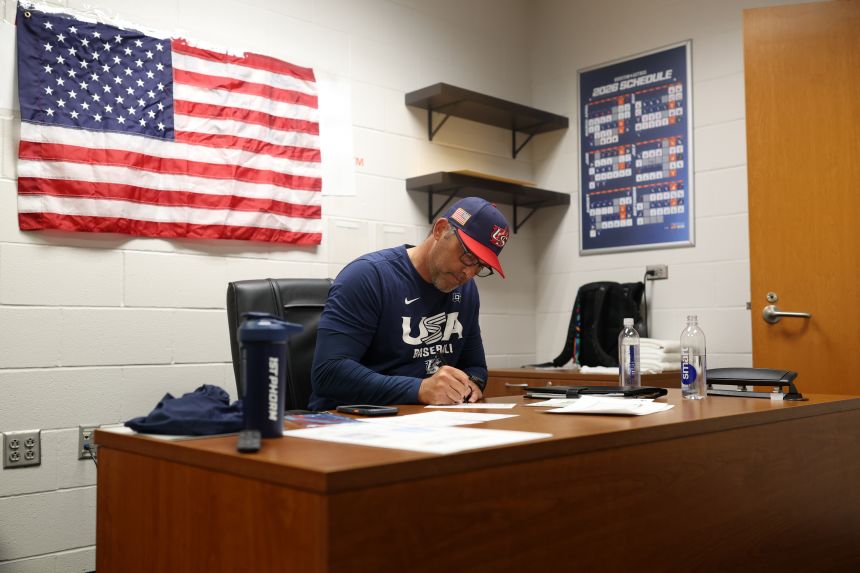 US manager Mark DeRosa fills out his lineup card in his office before the game against Italy.
