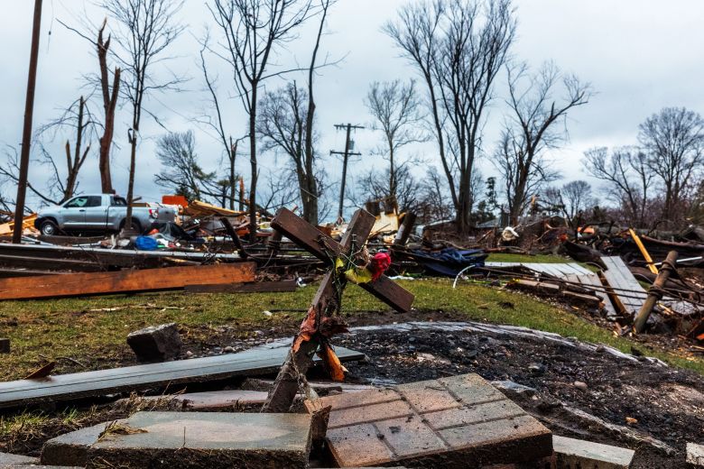 A cross stands near destroyed homes in Aroma Park, Illinois, on Wednesday.